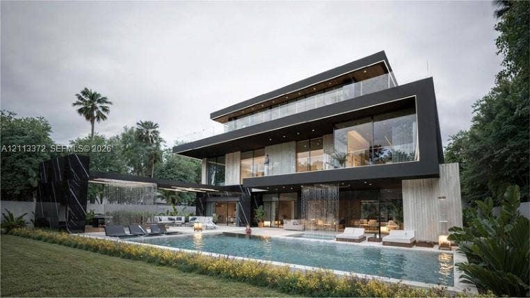 3312 NE 16th Court, Fort Lauderdale, FL 33305 Modern three-story architectural residence featuring expansive floor-to-ceiling glass walls, integrated water features, private balconies with glass railings, and an in-ground swimming pool