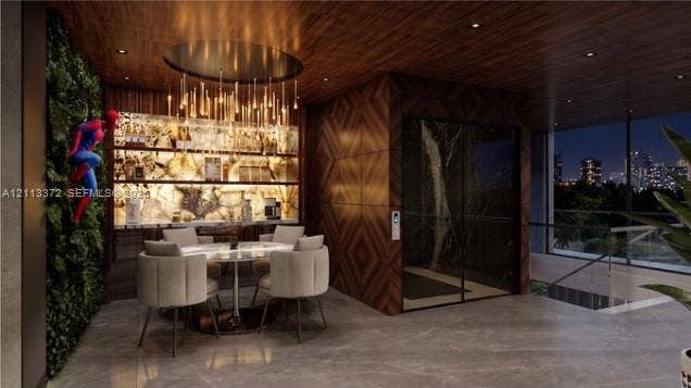 3312 NE 16th Court, Fort Lauderdale, FL 33305 Wood-paneled ceilings, integrated backlighting, vertical interior garden wall, floor-to-ceiling glass enclosure, and stone-finish flooring