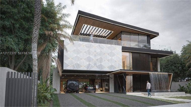 3312 NE 16th Court, Fort Lauderdale, FL 33305 Contemporary multi-level exterior featuring a geometric stone facade, integrated water feature, wood-paneled ceiling overhangs, expansive glass curtain walls, and a glass-railed upper-level terrace