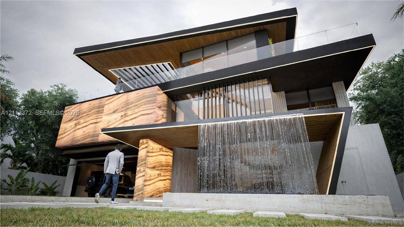 3312 NE 16th Court, Fort Lauderdale, FL 33305 Contemporary multi-level exterior featuring a stone-clad facade, integrated water feature, wood-finish soffits, and glass-paneled balconies