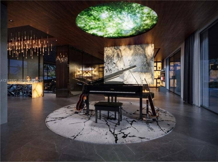 3312 NE 16th Court, Fort Lauderdale, FL 33305 Large-format tile flooring, wood-paneled ceiling, integrated circular illuminated ceiling feature, and backlit stone accent wall