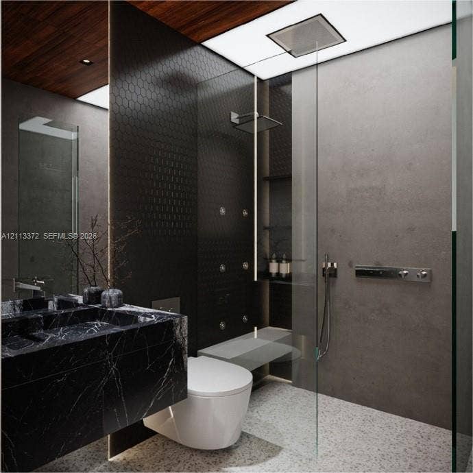 3312 NE 16th Court, Fort Lauderdale, FL 33305 Custom floating vanity with a dark stone finish, walk-in shower featuring a recessed rain showerhead and body sprays, floor-to-ceiling glass enclosure, matte-finish wall tiles, and wood-finish ceiling detailing