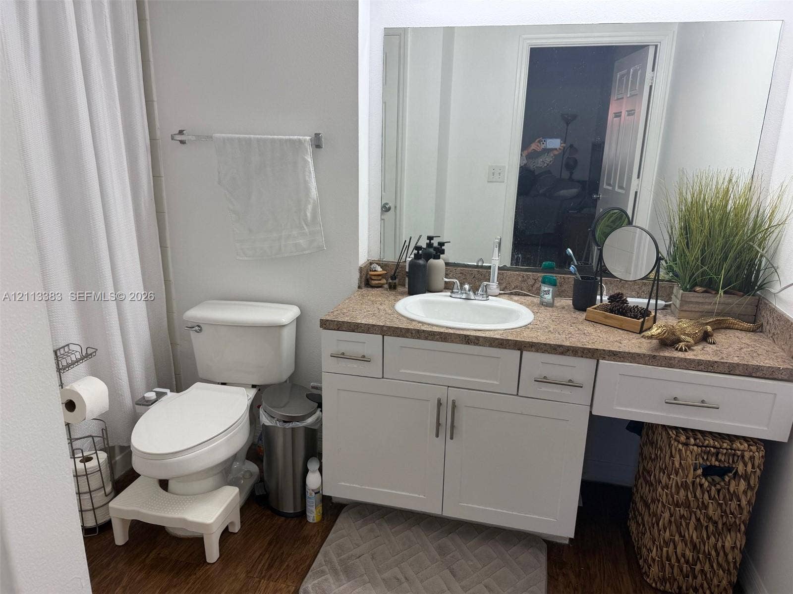 200 SW 117th Terrace, #10103, Pembroke Pines, FL 33025 Bathroom featuring a white vanity cabinet with shaker-style doors, an integrated countertop with an oval drop-in sink, and a large frameless wall-mounted mirror