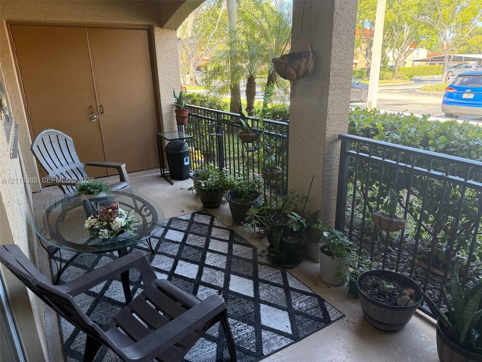 200 SW 117th Terrace, #10103, Pembroke Pines, FL 33025 Covered balcony featuring concrete flooring, a lockable storage closet, and black metal railings