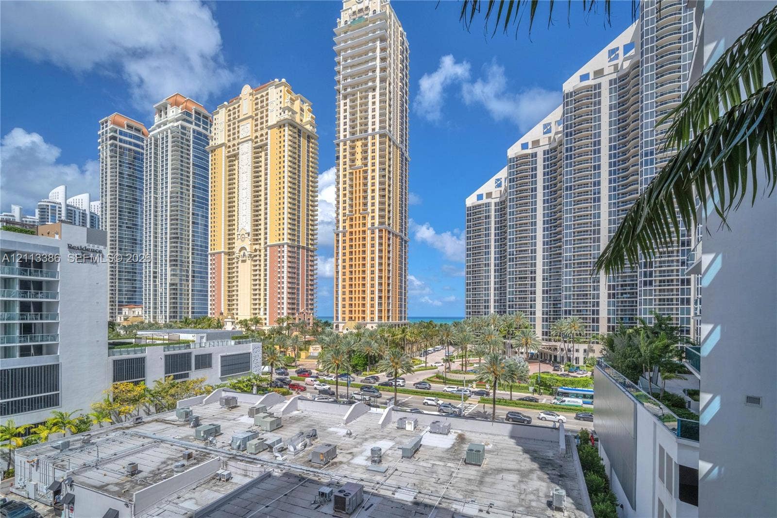 High-rise urban landscape featuring contemporary multi-story structures, glass-paneled architecture, and mature palm tree landscaping