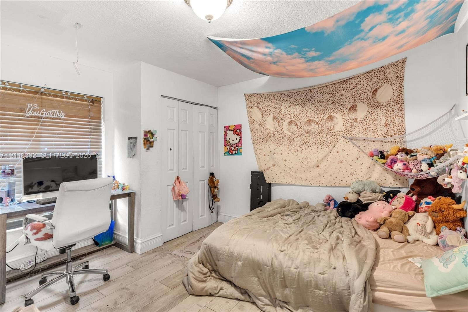 10705 SW 134th Court, Miami, FL 33186 Bedroom featuring wood-finish flooring, white bi-fold closet doors, a ceiling-mounted light fixture, and a large window with horizontal blinds