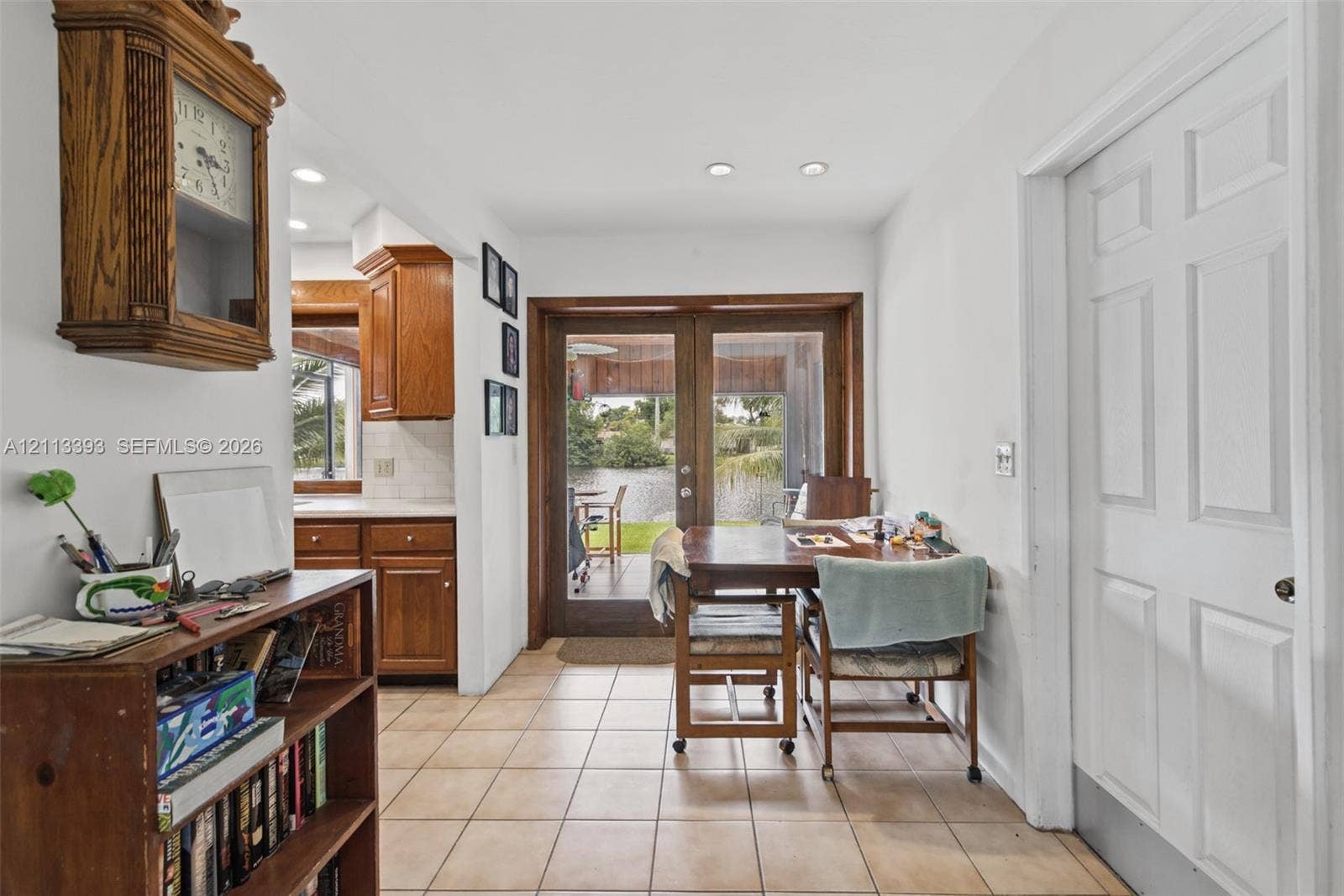 4136 SW 49th Street, Dania Beach, FL 33314 Ceramic tile flooring, wood-framed French doors, and recessed lighting, with wood cabinetry visible in the background