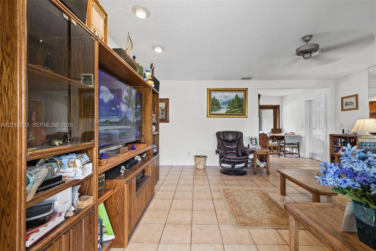 4136 SW 49th Street, Dania Beach, FL 33314 Built-in wood cabinetry, tile flooring, recessed lighting, and a ceiling fan