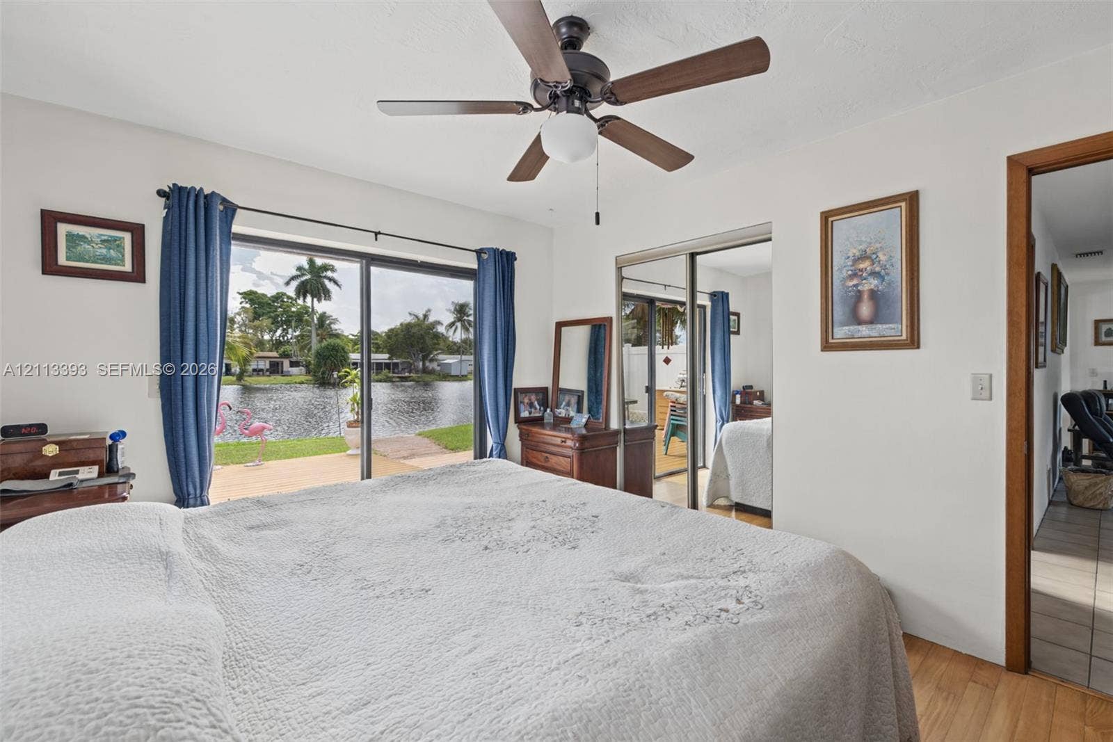 4136 SW 49th Street, Dania Beach, FL 33314 Sliding glass doors, waterfront exposure, wood-finish flooring, and ceiling fan with integrated lighting