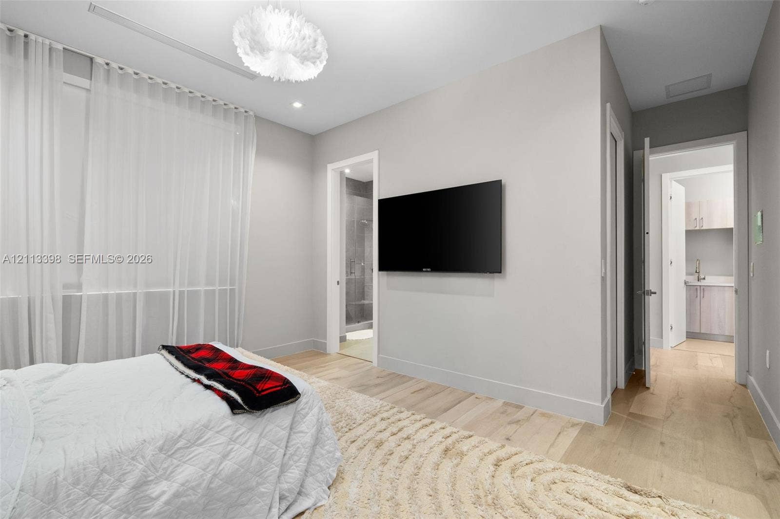 6814 NW 104th Court, #6814, Doral, Doral, FL 33178 Light-filled interior featuring neutral wall tones, wood-finish flooring, and recessed ceiling lighting