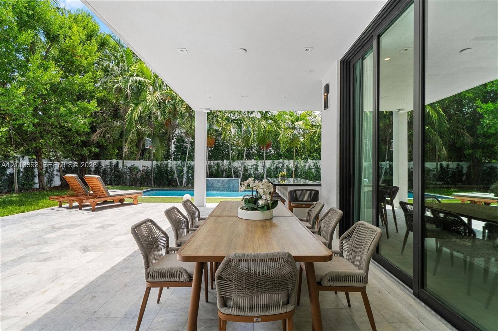 6814 NW 104th Court, #6814, Doral, Doral, FL 33178 Covered patio featuring stone tile flooring, recessed ceiling lighting, and floor-to-ceiling sliding glass doors
