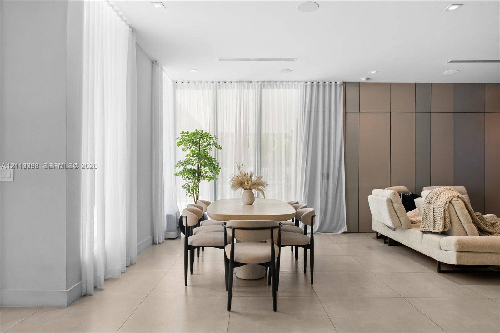 6814 NW 104th Court, #6814, Doral, Doral, FL 33178 Large-format tile flooring, recessed ceiling lighting, floor-to-ceiling drapery, and multi-tone paneled accent wall