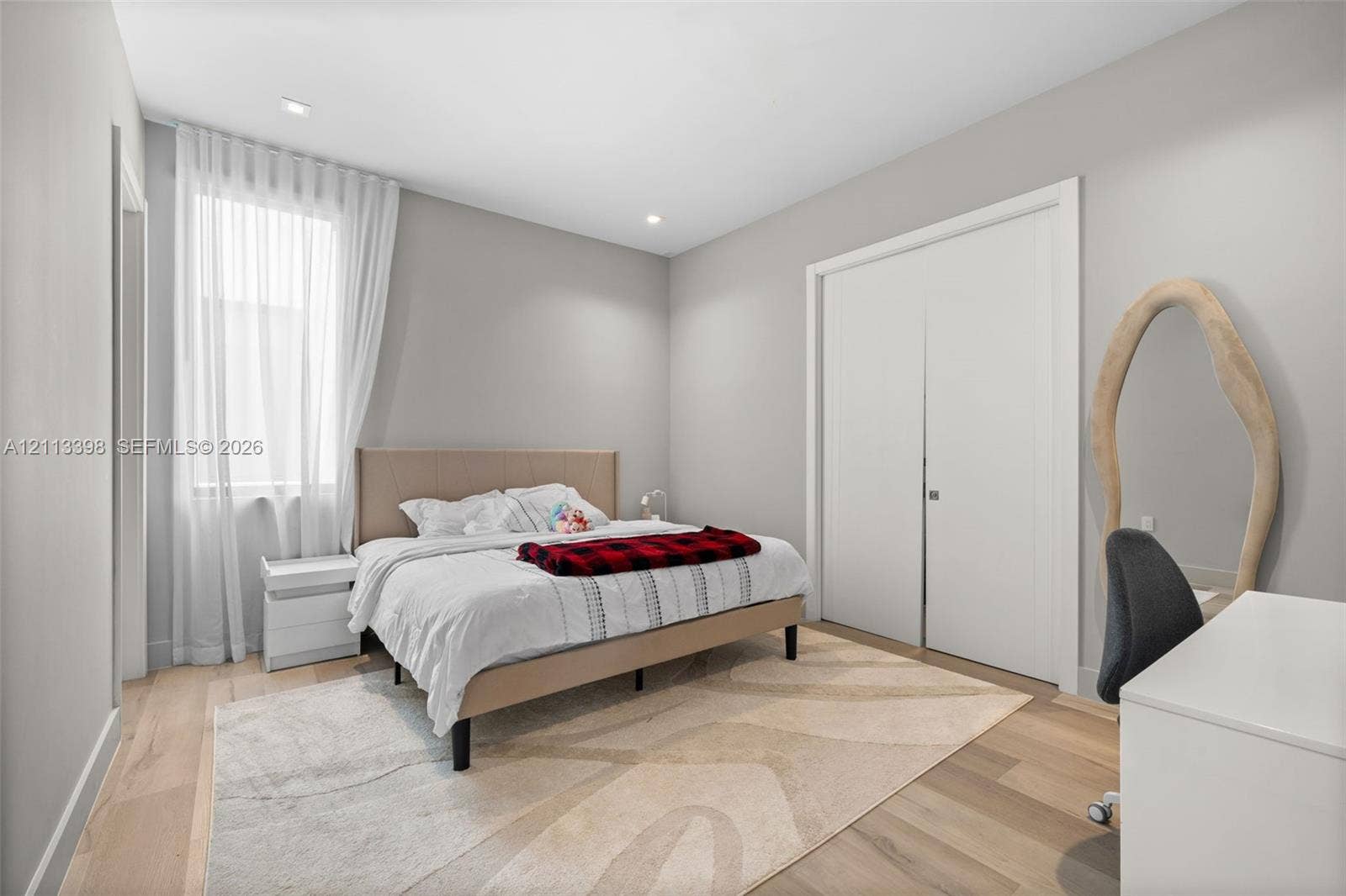 6814 NW 104th Court, #6814, Doral, Doral, FL 33178 Light-filled room featuring wood-finish flooring, recessed lighting, and a double-door closet with custom-finish trim