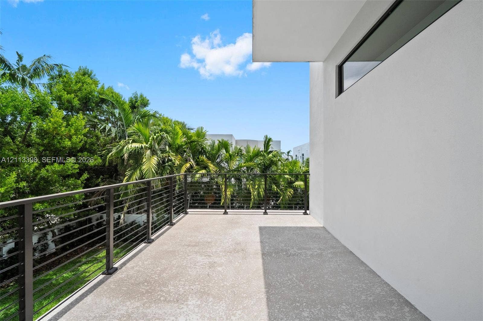 6814 NW 104th Court, #6814, Doral, Doral, FL 33178 Covered balcony featuring concrete flooring, horizontal cable railing, and stucco exterior finish