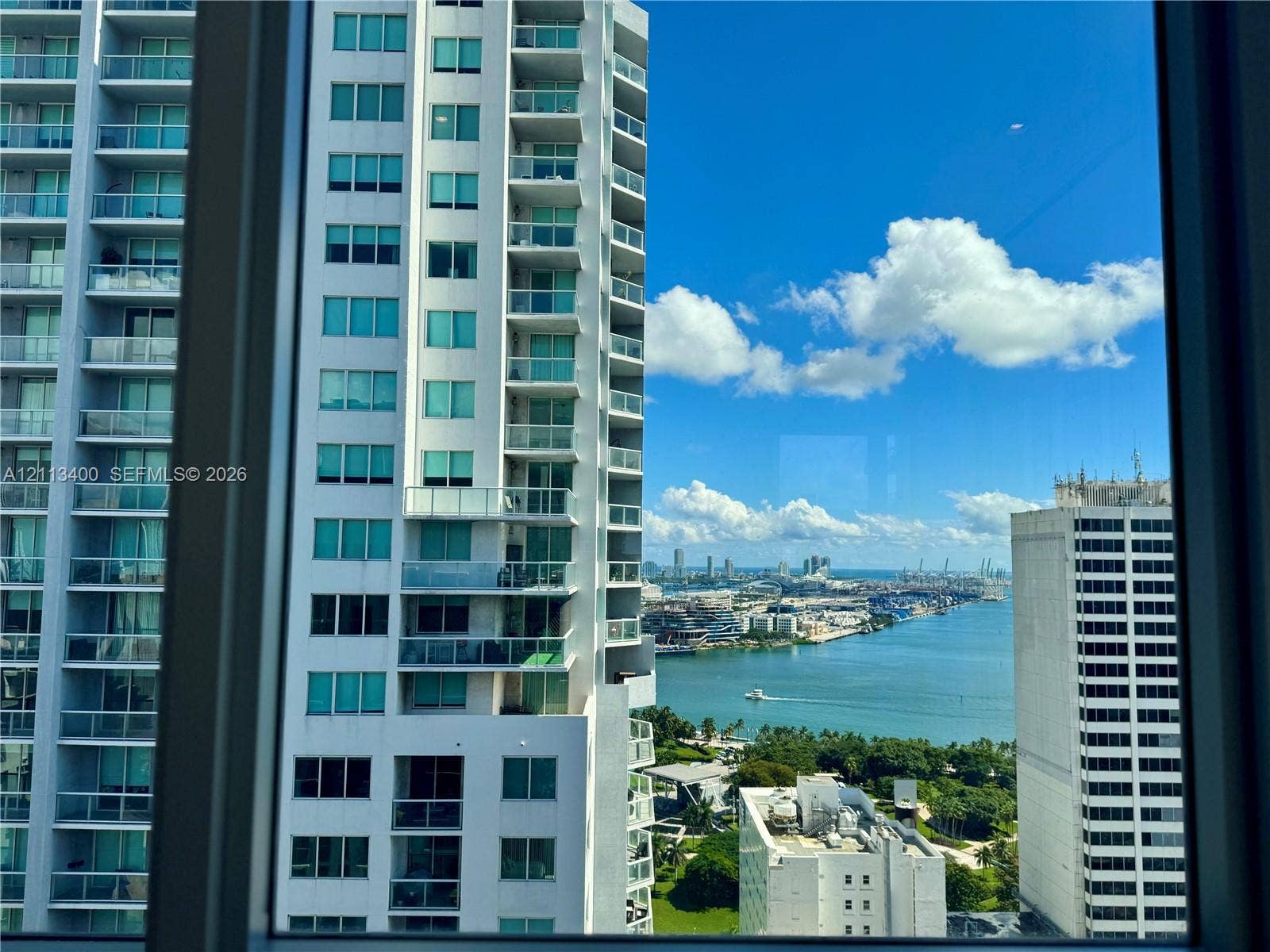 227 NE 2nd Street, #2105, Miami, FL 33132 High-rise elevation featuring expansive windows, panoramic water, and urban skyline scenery