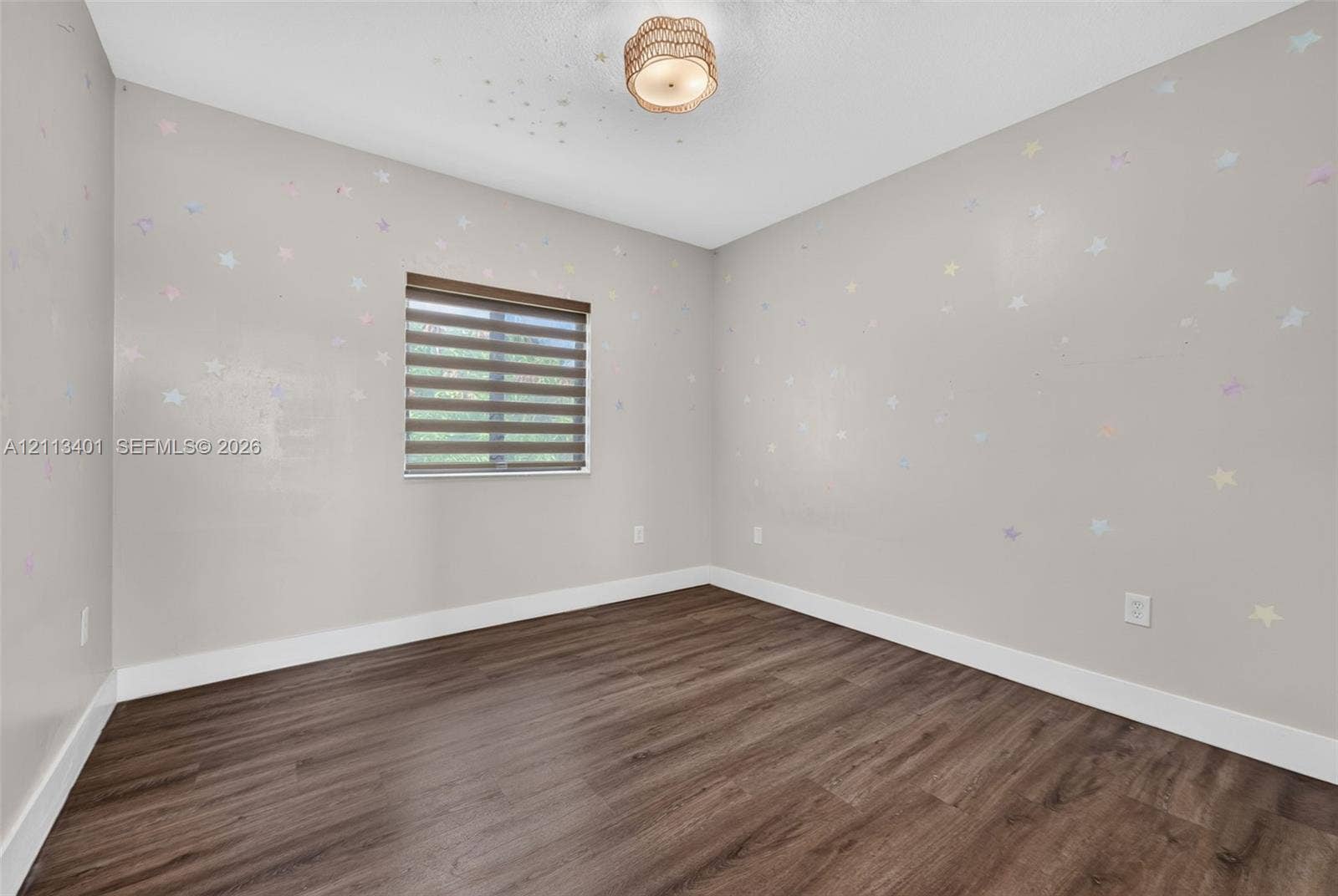 15891 SW 139th Street, Miami, Miami, FL 33196 Neutral interior space featuring wood-finish flooring, a contemporary semi-flush mount fixture, and a dual-shade roller window treatment
