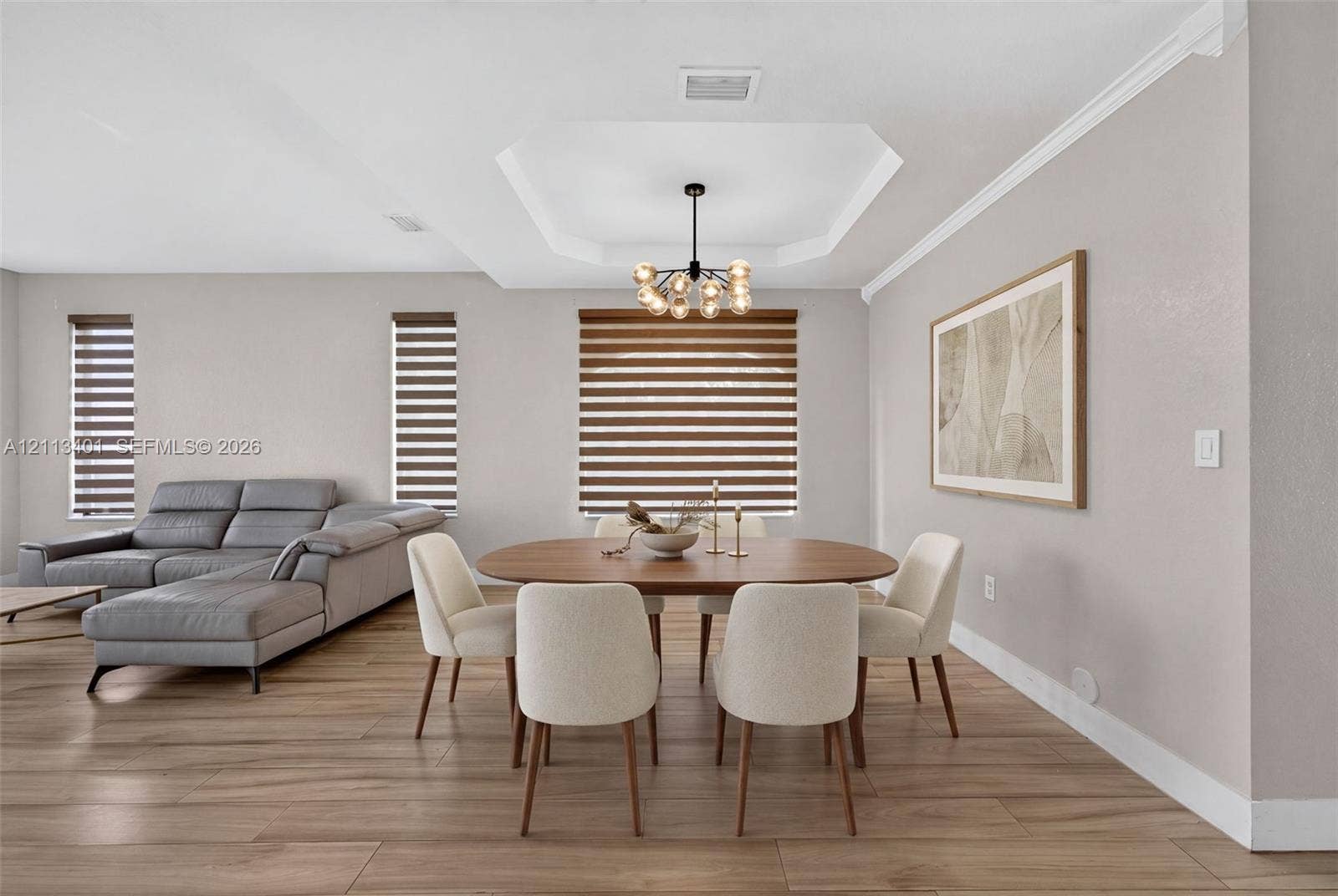 15891 SW 139th Street, Miami, Miami, FL 33196 Tray ceiling, wood-finish flooring, multi-light orb chandelier, and dual-shade window treatments