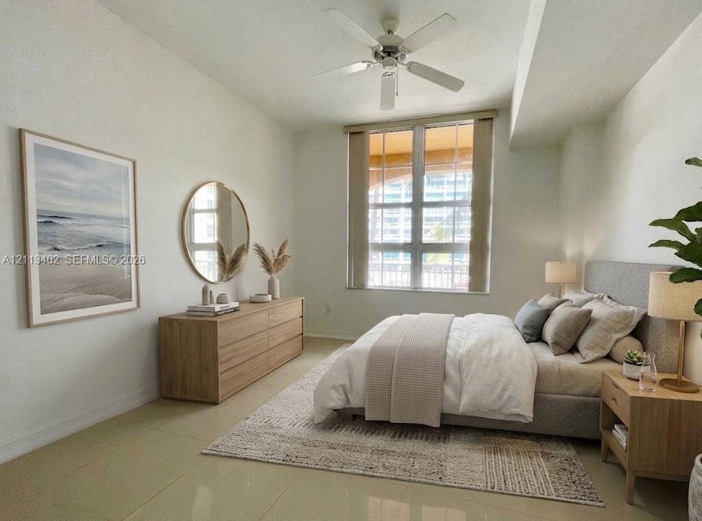 3001 NE 185th Street, #207, Aventura, FL 33180 Large grid window, neutral tile flooring, and ceiling fan with integrated lighting