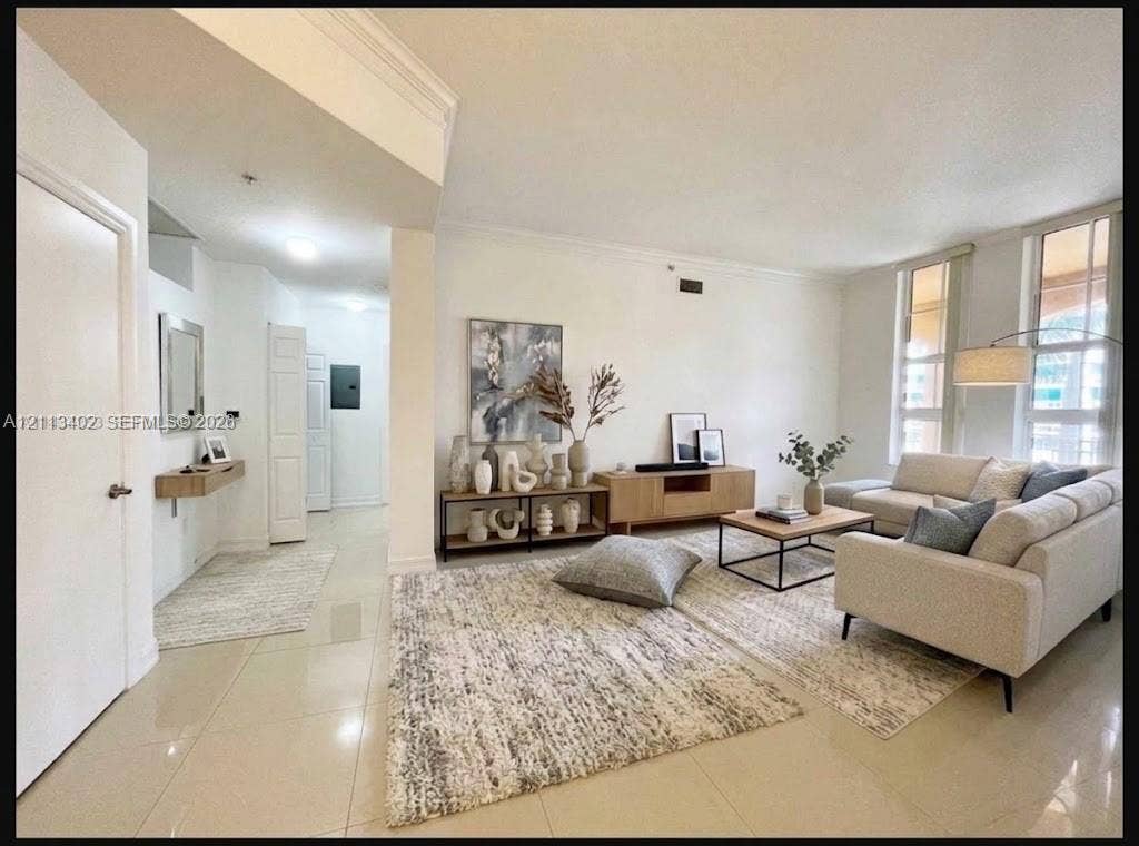 3001 NE 185th Street, #207, Aventura, FL 33180 Open-concept room featuring light-toned tile flooring, recessed ceiling lighting, crown molding, and floor-to-ceiling windows