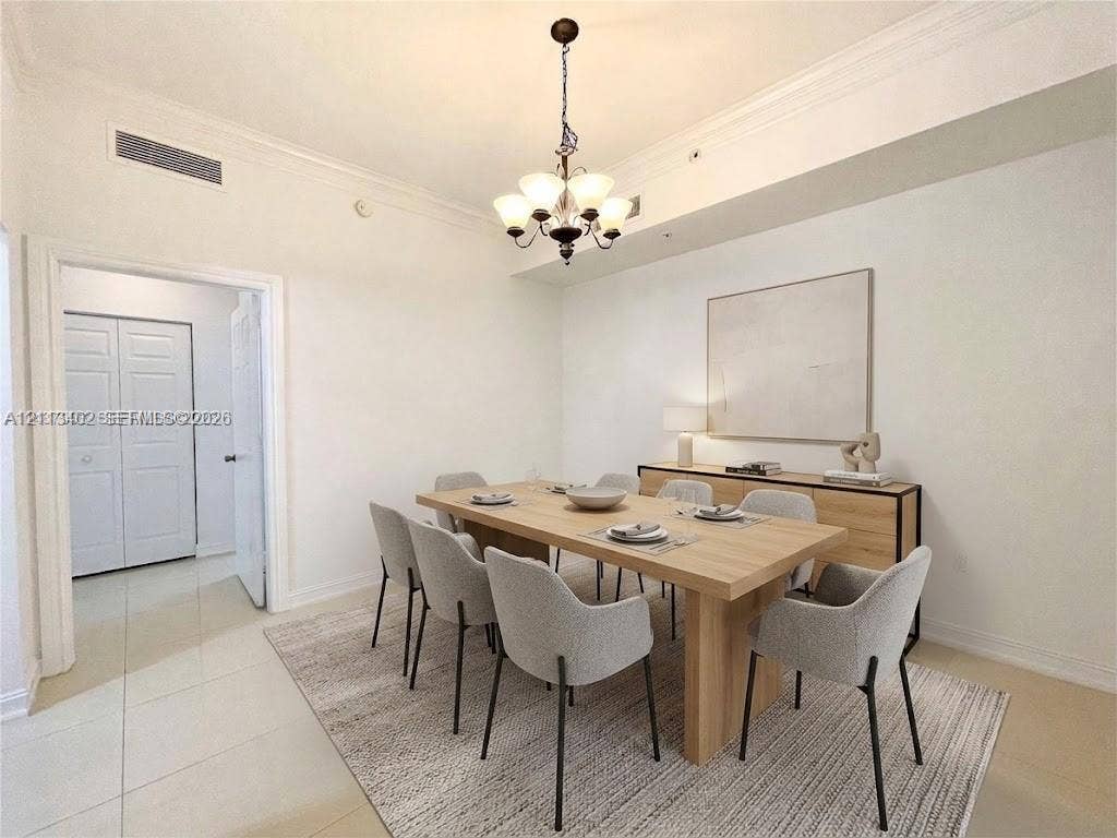 3001 NE 185th Street, #207, Aventura, FL 33180 Interior space featuring neutral wall paint, multi-tiered chandelier, crown molding, and large-format tile flooring