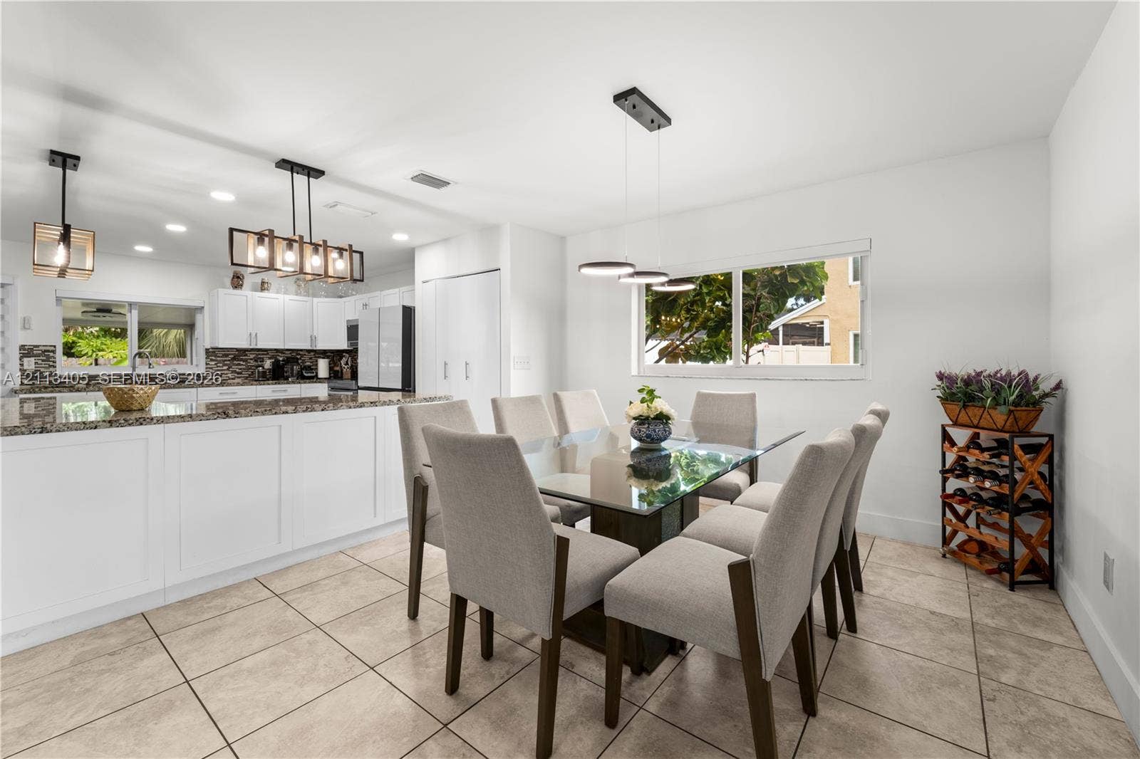 1675 S Goldeneye Lane, Homestead, FL 33035 Kitchen featuring white cabinetry, stone-finish countertops, tile flooring, and integrated pendant lighting