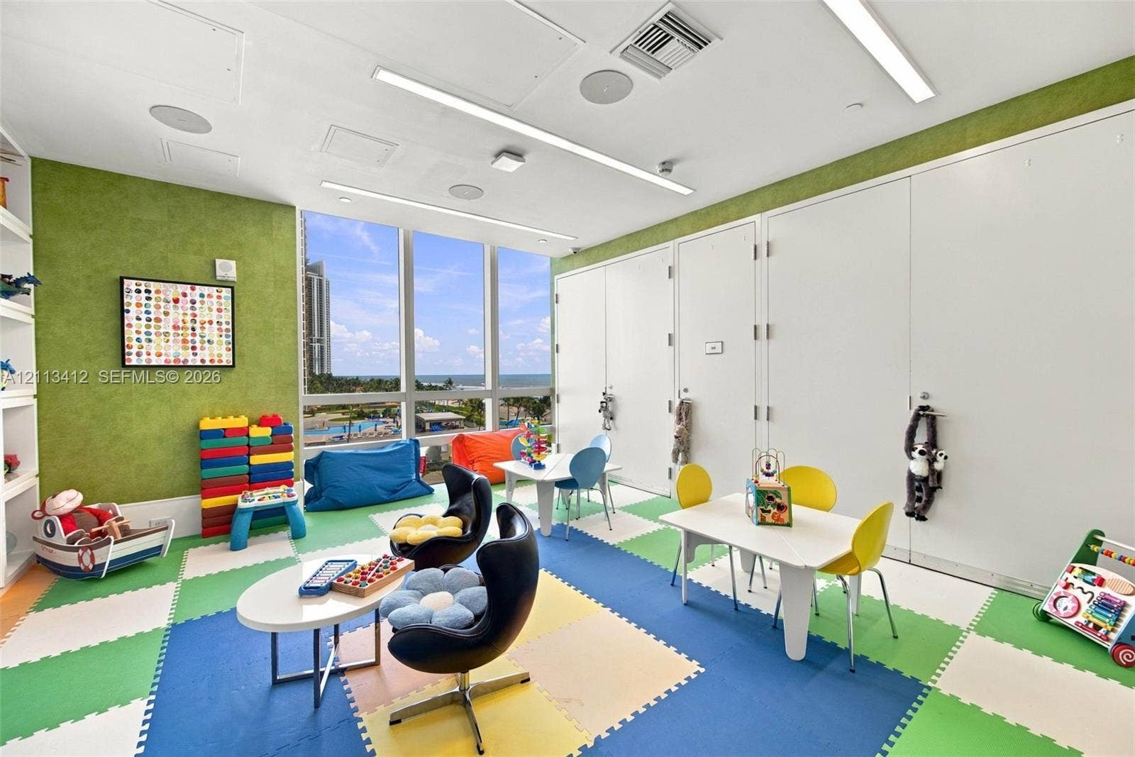 17475 Collins Avenue, #1802, Sunny Isles Beach, FL 33160 Floor-to-ceiling windows, built-in shelving, recessed ceiling lighting, and large-format tile flooring
