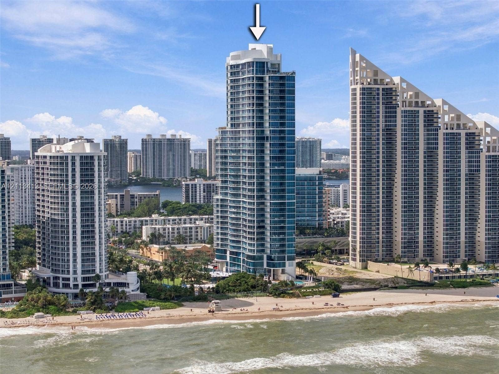 17475 Collins Avenue, #1802, Sunny Isles Beach, FL 33160 High-rise residential tower featuring a glass-facade exterior, private balconies, and an oceanfront location