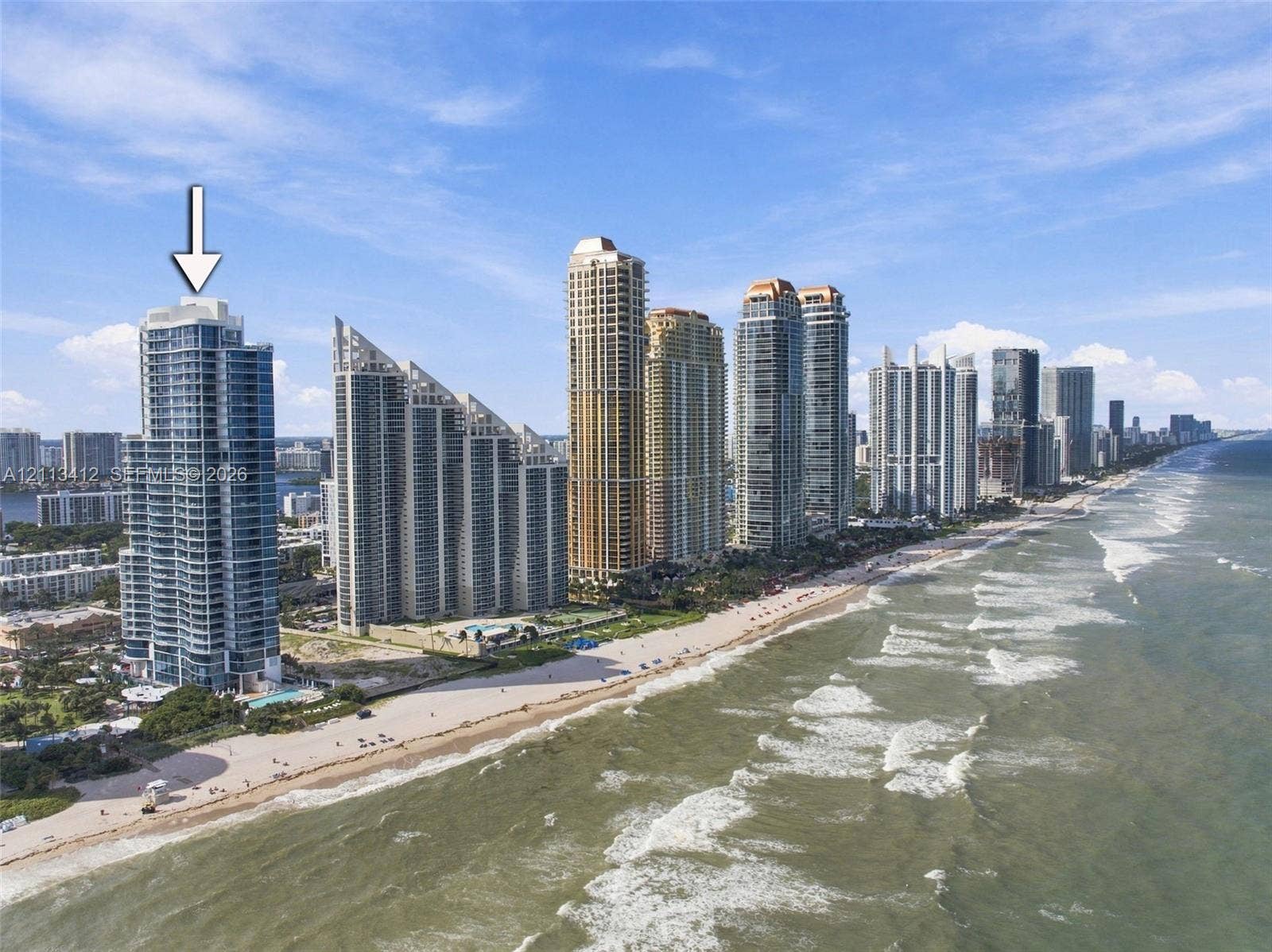 17475 Collins Avenue, #1802, Sunny Isles Beach, FL 33160 High-rise oceanfront residential tower featuring floor-to-ceiling glass paneling and direct coastal positioning