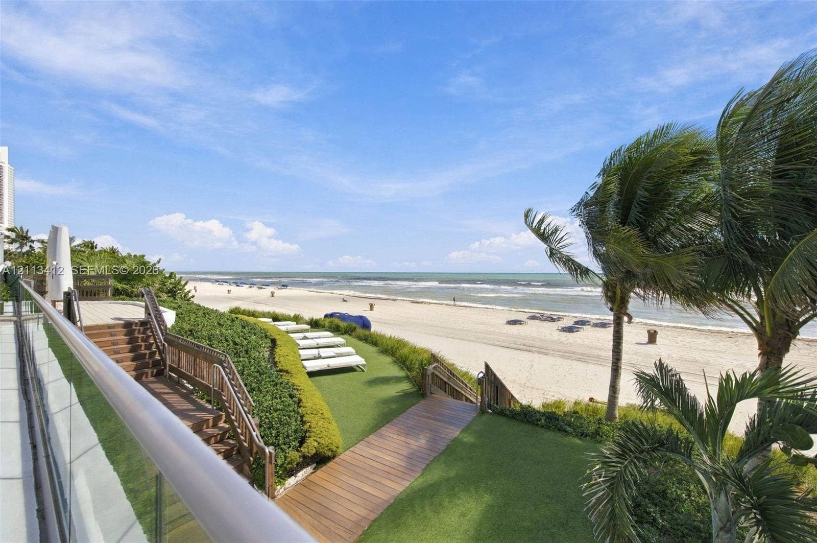 17475 Collins Avenue, #1802, Sunny Isles Beach, FL 33160 Outdoor terrace featuring glass paneled railings, wood-finish decking, tiered stairways, and private beach access
