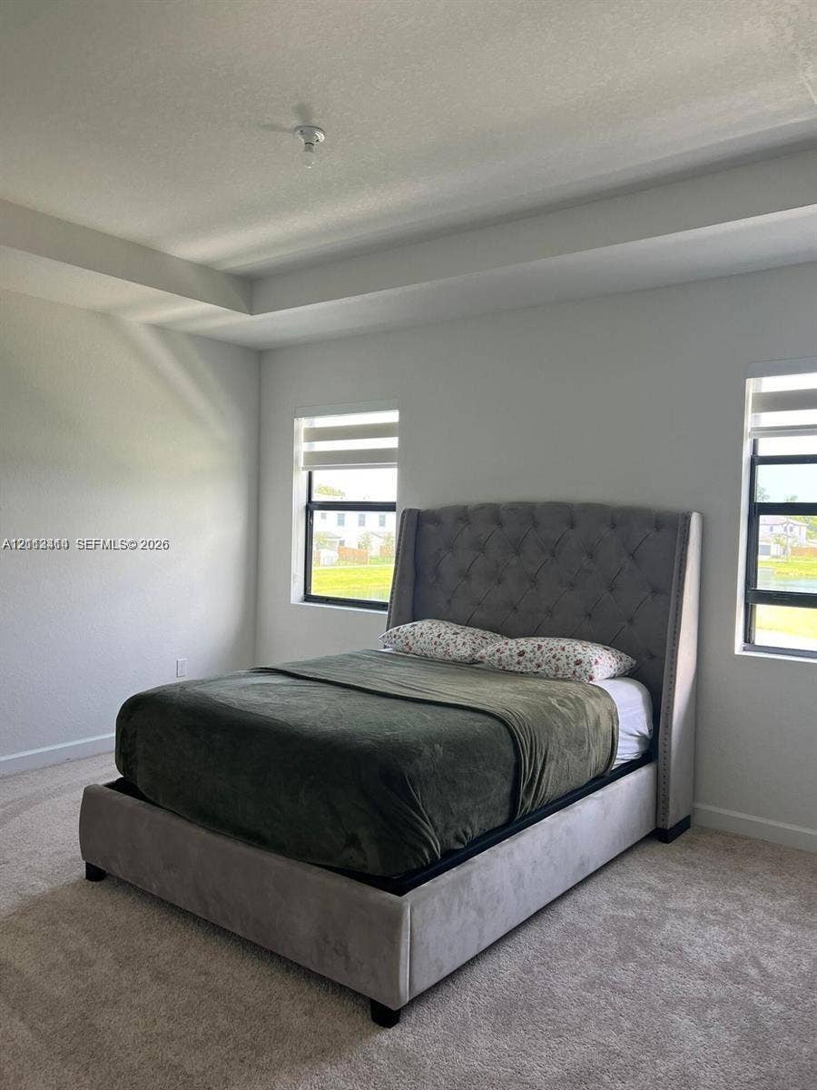 3024 Green Palm Court, #5838, Dania, Dania Beach, FL 33312 Tray ceiling, neutral carpeting, and multi-paned windows with black frames