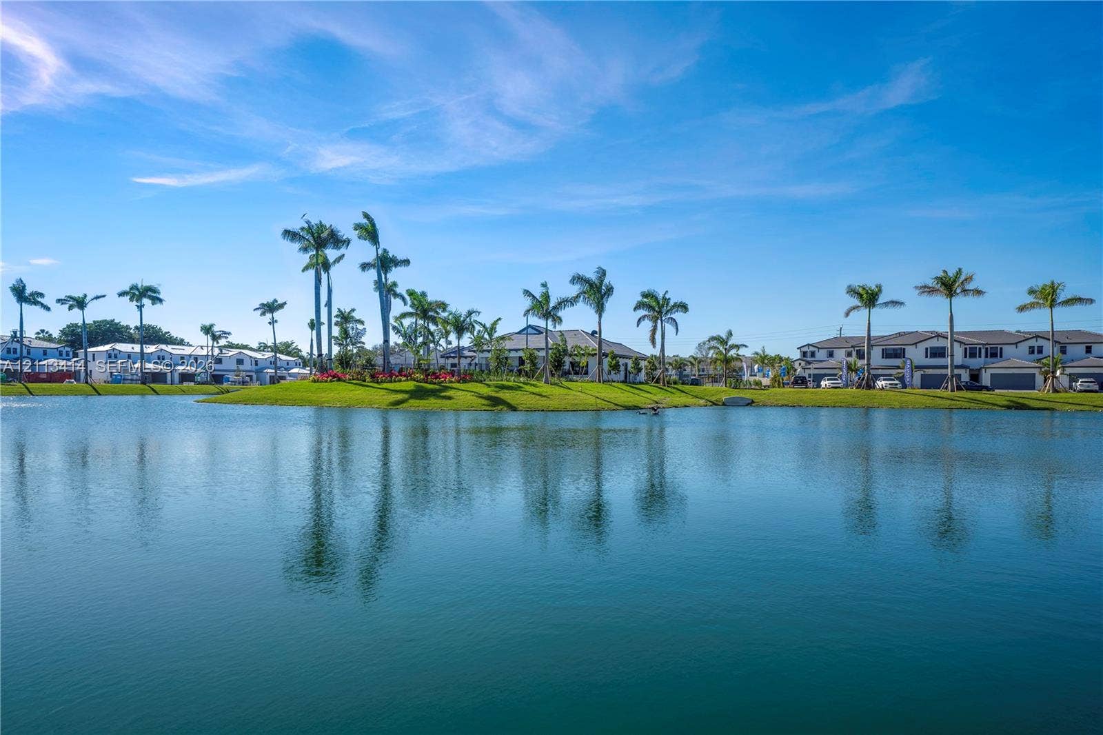 3024 Green Palm Court, #5838, Dania, Dania Beach, FL 33312 Waterfront property featuring a serene lake, manicured landscaping, and mature palm trees