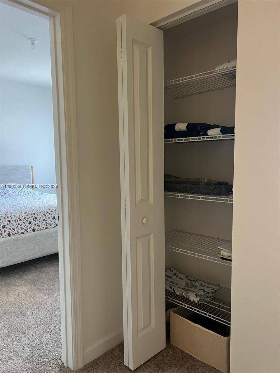 3024 Green Palm Court, #5838, Dania, Dania Beach, FL 33312 Storage closet featuring white bifold doors and integrated wire shelving