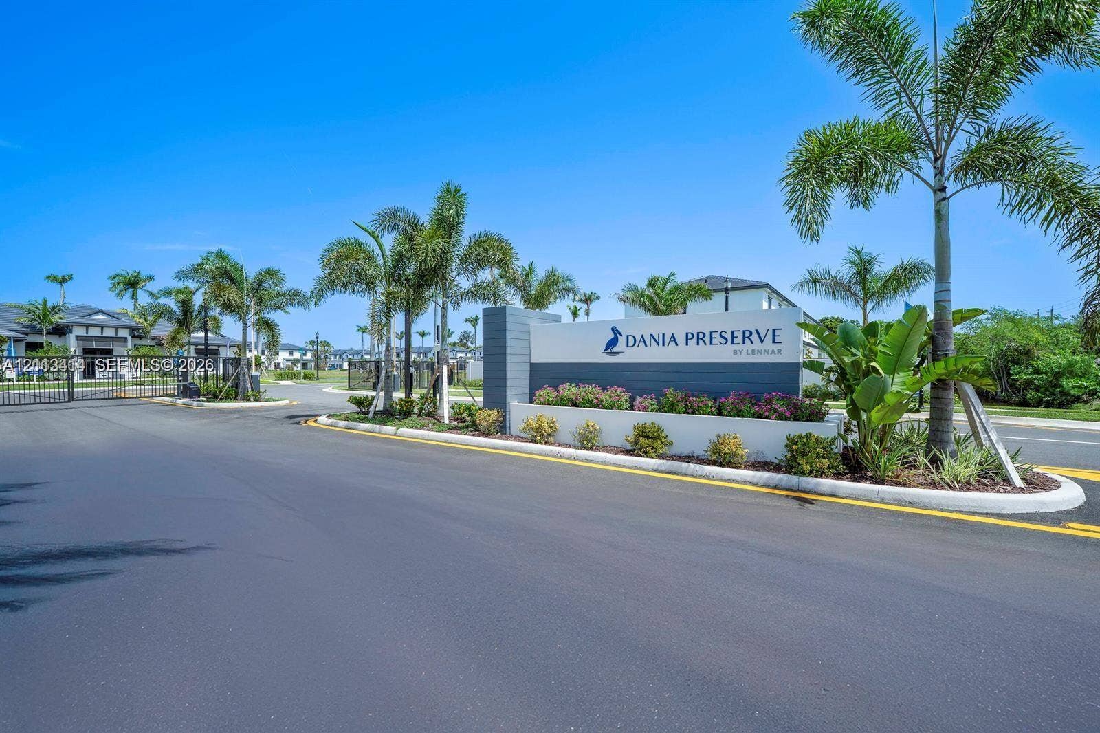 3024 Green Palm Court, #5838, Dania, Dania Beach, FL 33312 Gated entrance featuring professional hardscaping, manicured landscaping, and mature palm trees