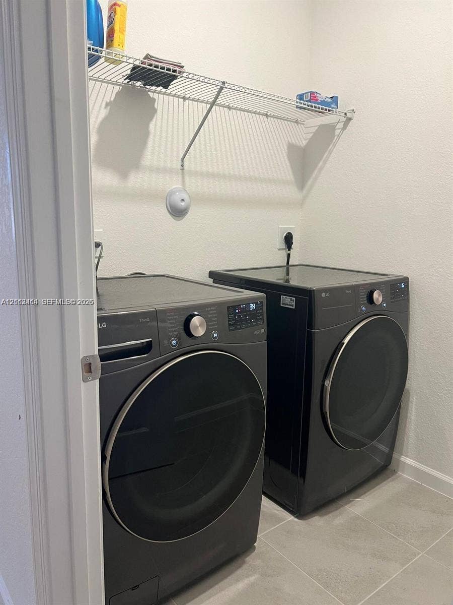 3024 Green Palm Court, #5838, Dania, Dania Beach, FL 33312 Laundry area featuring large-format neutral tile flooring and overhead wire shelving