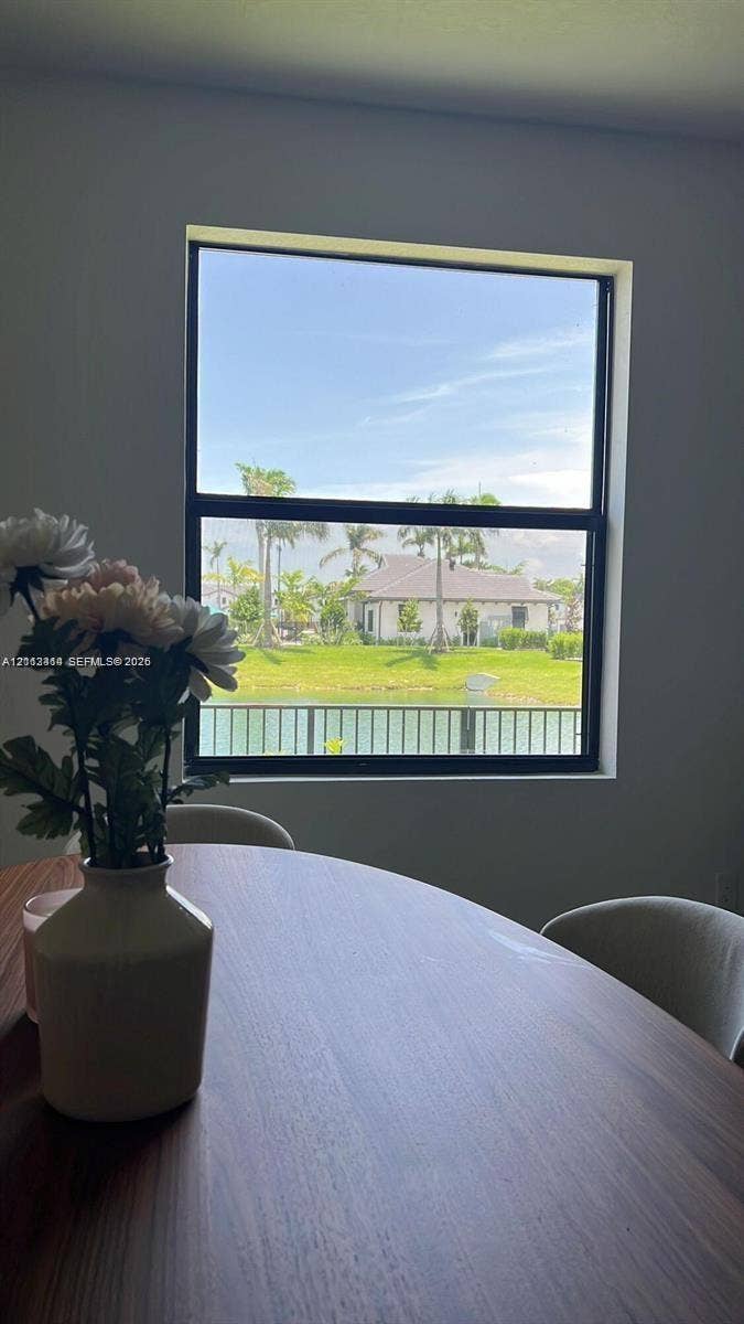 3024 Green Palm Court, #5838, Dania, Dania Beach, FL 33312 Large single-hung window with a black frame, showcasing water and green space