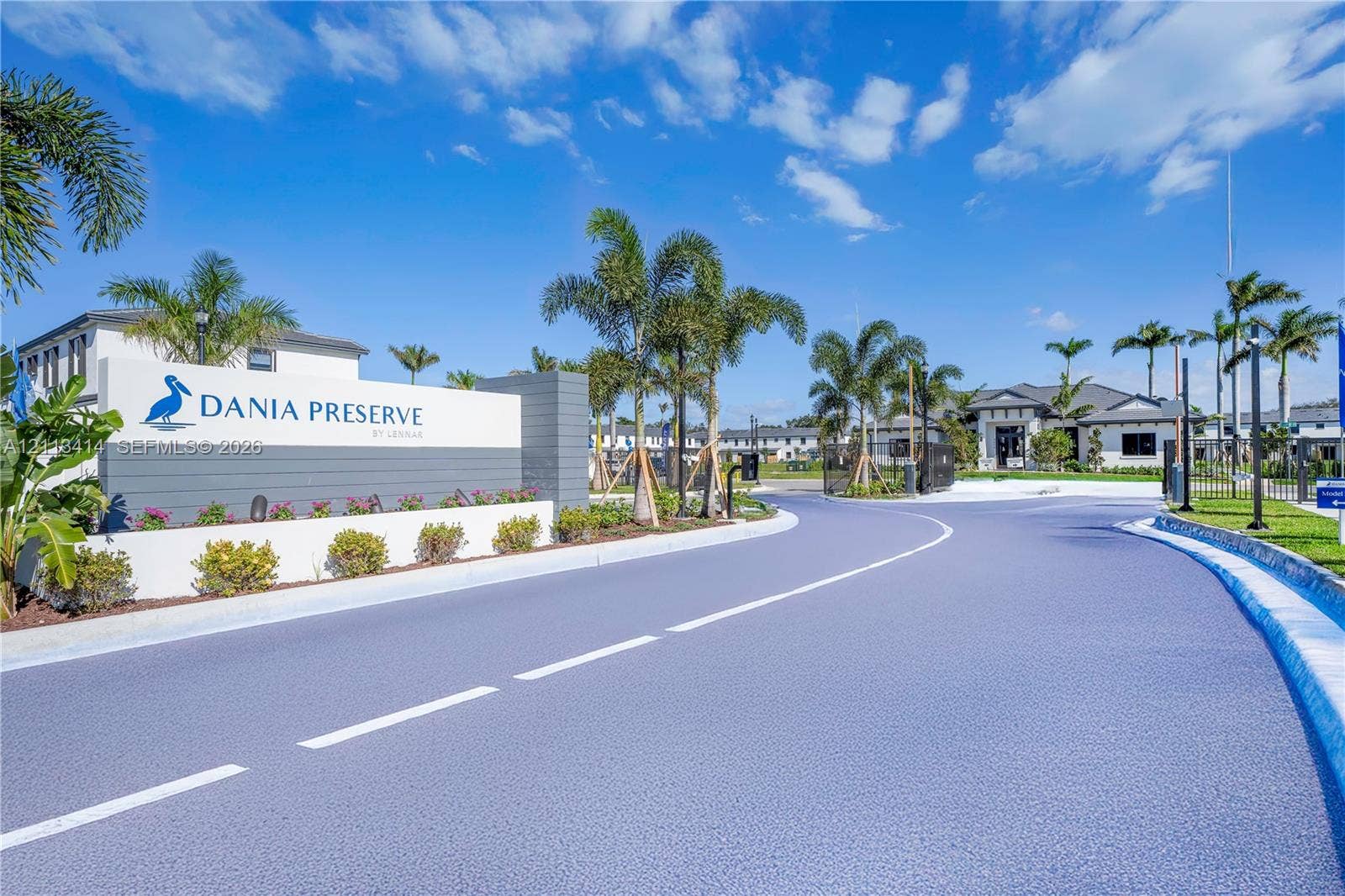 3024 Green Palm Court, #5838, Dania, Dania Beach, FL 33312 Community entrance featuring a branded masonry monument sign, mature palm landscaping, paved roadways, and gated access