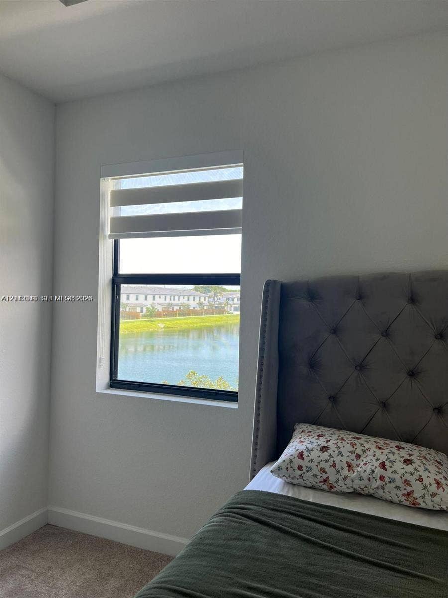 3024 Green Palm Court, #5838, Dania, Dania Beach, FL 33312 Neutral-toned walls, carpeted flooring, and a window featuring a dual-layer roller shade