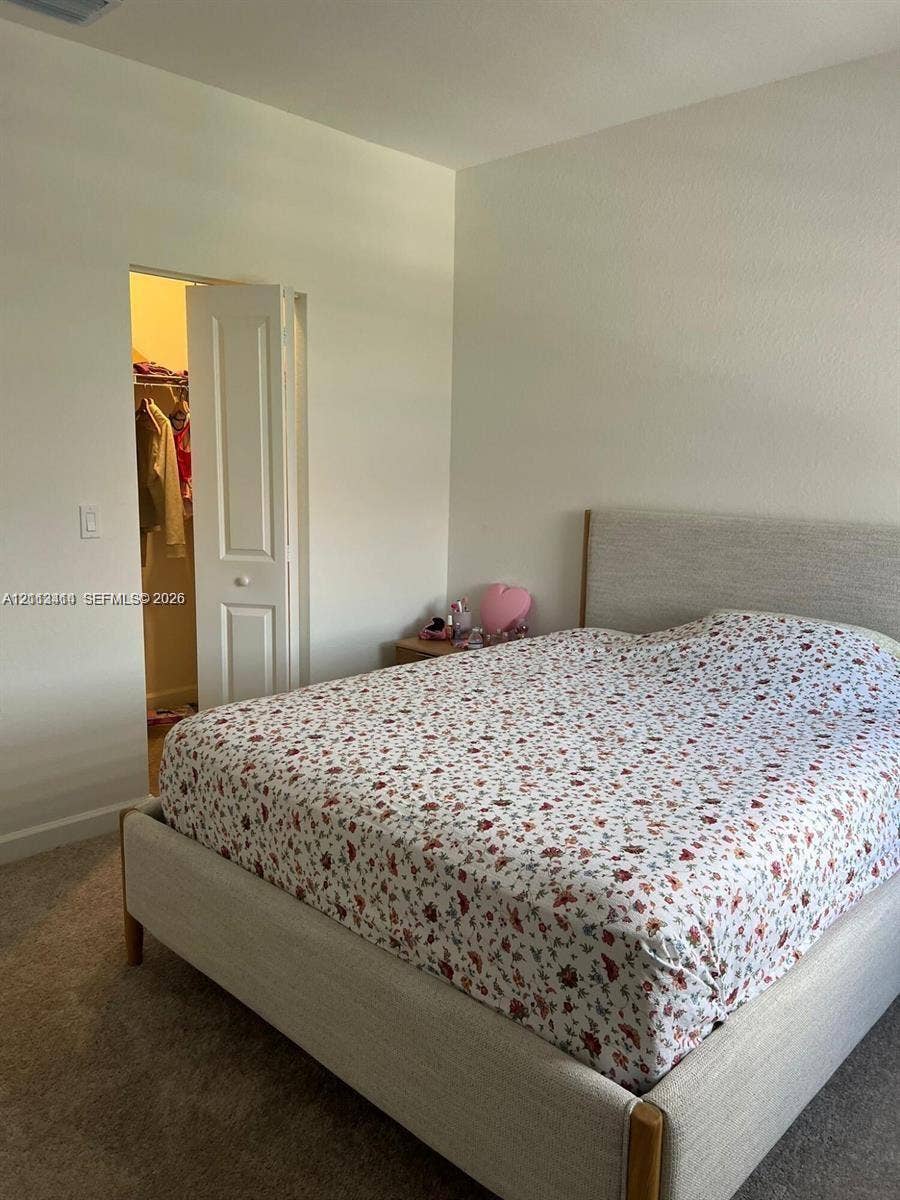 3024 Green Palm Court, #5838, Dania, Dania Beach, FL 33312 Neutral wall color, carpeted flooring, and a walk-in closet with a paneled door
