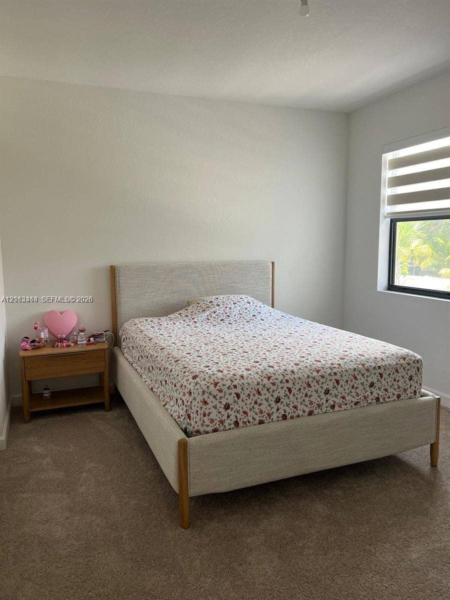 3024 Green Palm Court, #5838, Dania, Dania Beach, FL 33312 Neutral-toned carpeted flooring, neutral wall paint, and a window featuring horizontally striped roller shades