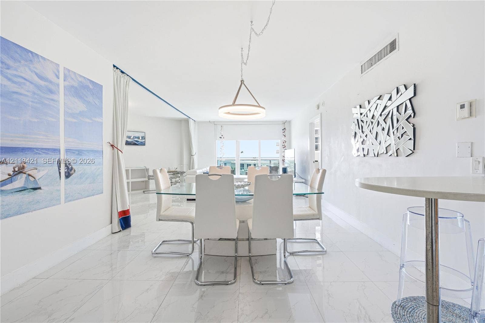 3901 S Ocean Drive, #5L, Hollywood, FL 33019 Open-concept space featuring polished stone-finish tile flooring, a contemporary circular pendant light, and recessed ceiling lighting