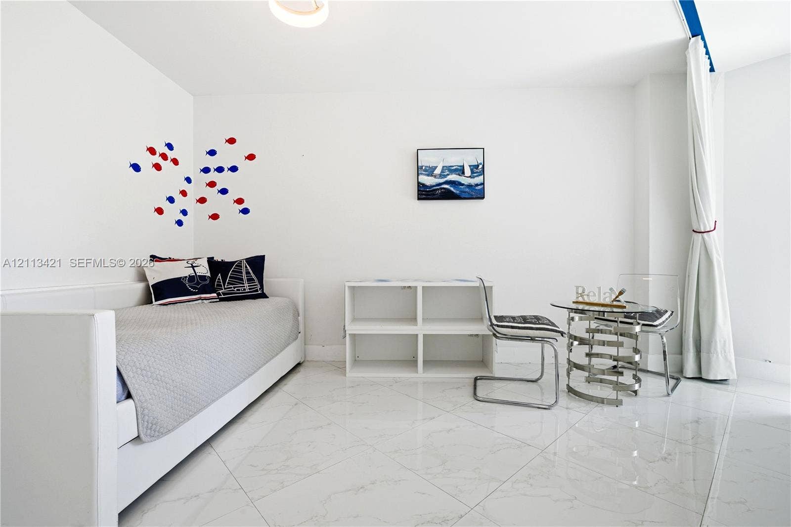 3901 S Ocean Drive, #5L, Hollywood, FL 33019 Polished stone-finish tile flooring, white walls, and built-in shelving unit