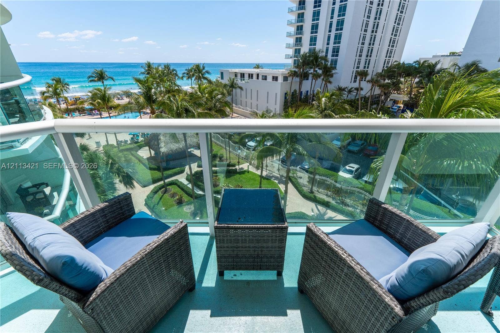 3901 S Ocean Drive, #5L, Hollywood, FL 33019 Private balcony featuring a glass-panel railing and painted concrete flooring