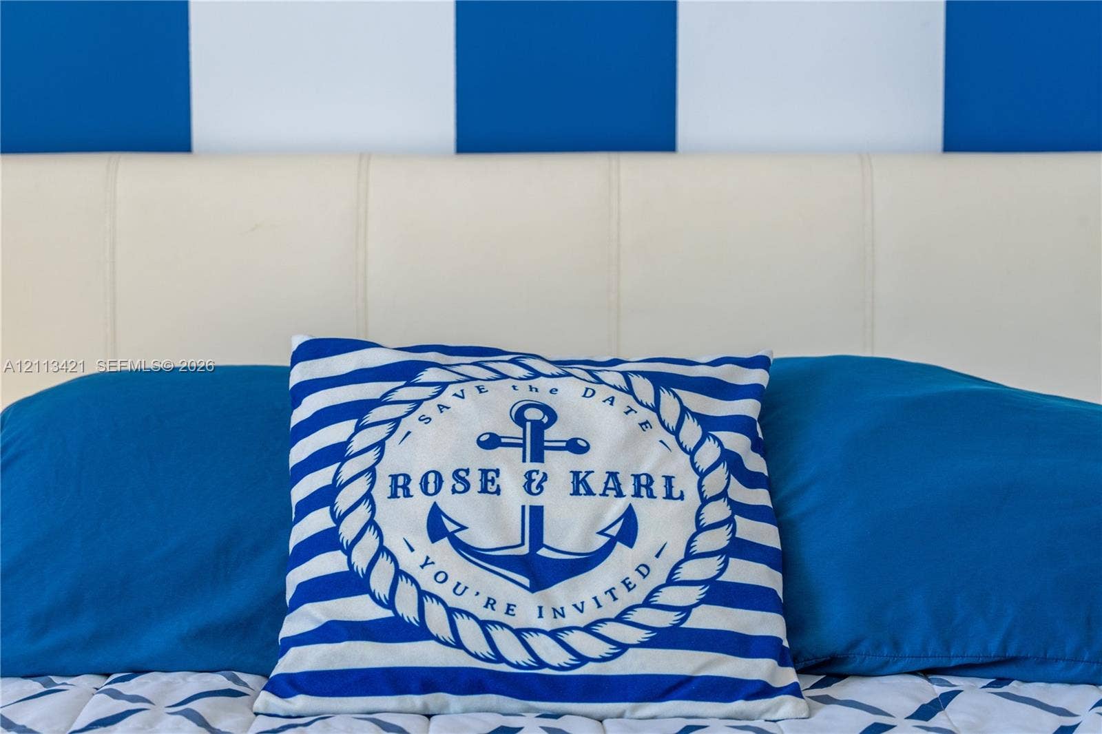 3901 S Ocean Drive, #5L, Hollywood, FL 33019 Blue and white vertically striped wall treatment and off-white upholstered headboard