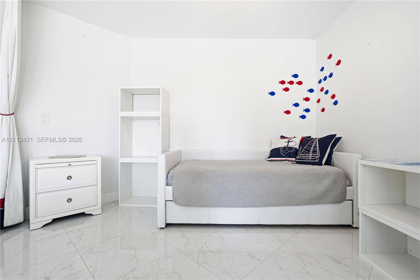 3901 S Ocean Drive, #5L, Hollywood, FL 33019 Bright interior space featuring polished tile flooring, white built-in shelving units, and clean white walls