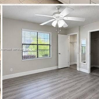 10360 SW 150th Court, #12207, Miami, Miami, FL 33196 Wood-finish flooring, multi-blade ceiling fan with integrated lighting, and window with horizontal blinds