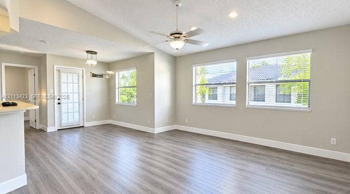 10360 SW 150th Court, #12207, Miami, Miami, FL 33196 Vaulted ceilings featuring a central white ceiling fan, wood-finish flooring, multi-pane glass door, and recessed lighting