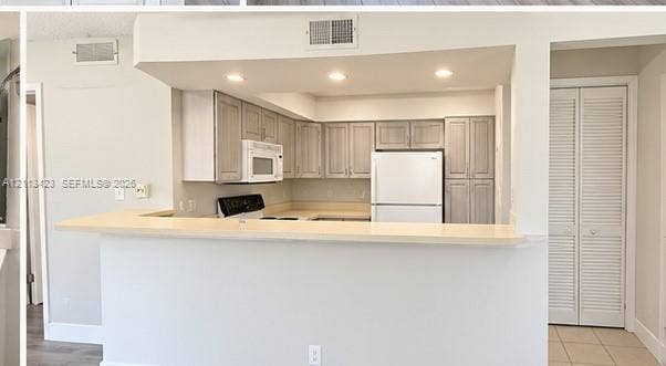 10360 SW 150th Court, #12207, Miami, Miami, FL 33196 Kitchen featuring light-toned cabinetry, solid surface countertop, recessed lighting, and white appliances