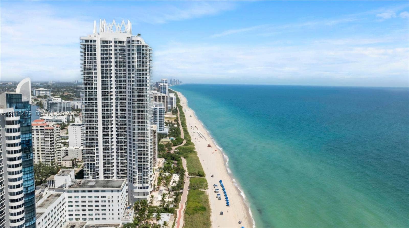 6365 Collins Avenue, #909, Miami Beach, FL 33141 High-rise tower featuring a tiered architectural design and direct frontage on a sandy coastline