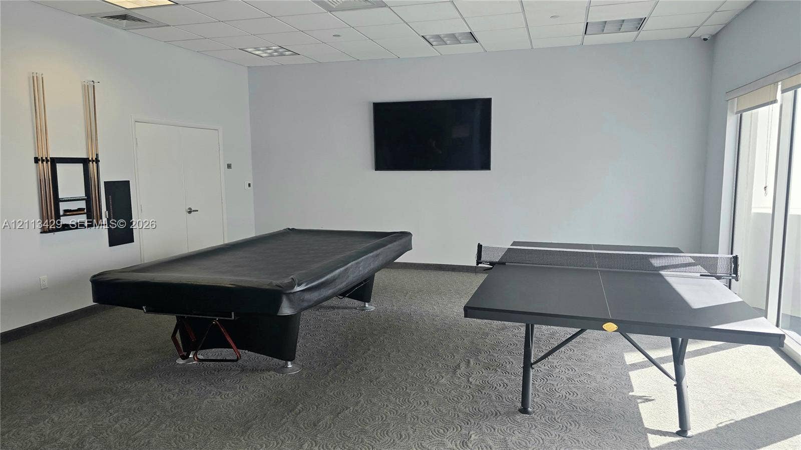 6365 Collins Avenue, #909, Miami Beach, FL 33141 Spacious room featuring a drop ceiling, wall-to-wall carpeting, and large floor-to-ceiling windows