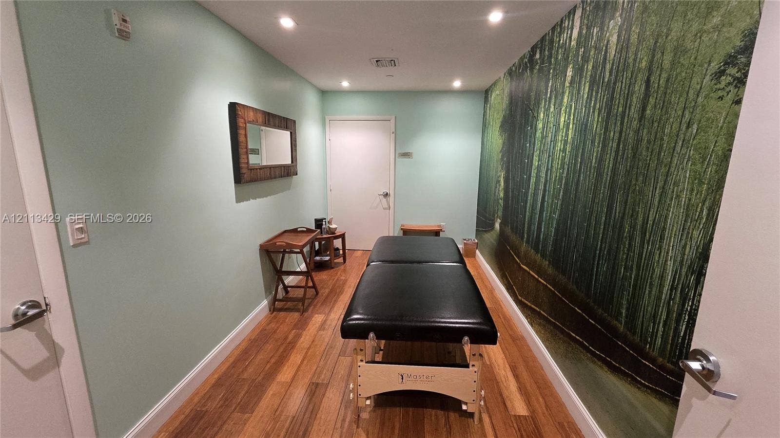 6365 Collins Avenue, #909, Miami Beach, FL 33141 Room featuring wood-finish flooring, recessed lighting, and a large-scale graphic wall mural